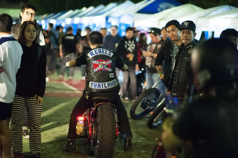 Cyclists from the Rebel bike club park bikes to be displayed.