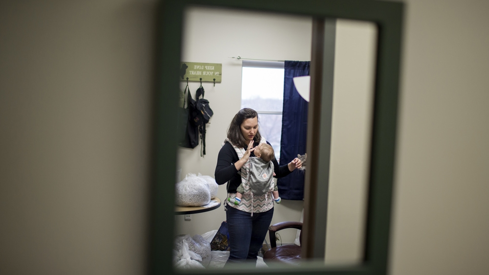 A typical day, Rebecca says, will see her bringing Zach to work for six to seven hours; he nurses, he naps, he plays in his Pack and Play [James Brosher/Al Jazeera] 