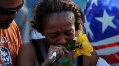 Victor Taylor supports Keaka Wallace who says she was a patrol partner of the Dallas Area Rapid Transit police officer Brent Thompson who was shot dead [REUTERS]