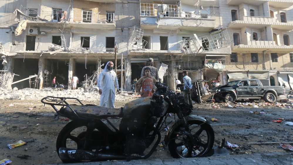 People inspect the damage after an airstrike in the rebel held area of Tariq al-Bab district of Aleppo