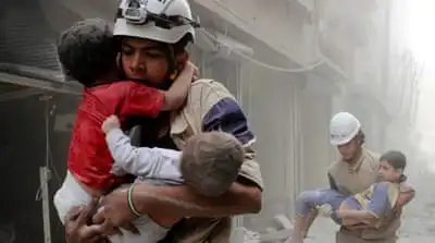Members of the Civil Defence rescue children after what activists said was an air strike by forces loyal to Assad in al-Shaar neighbourhood of Aleppo, Syria [Reuters]