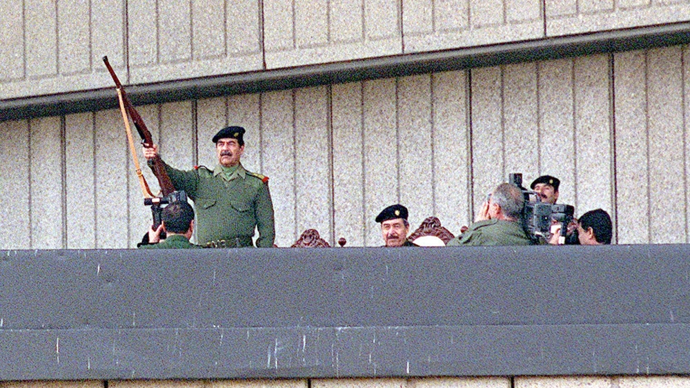 Iraqi president Saddam Hussein raises his rifle in a salute and fires it November 20, 2000 durring Grand Day of Quds festivities in Baghdad. Grand Day of Quds celebrates Iraq””s commitment to liberating Jerusalem from Israeli rule.
