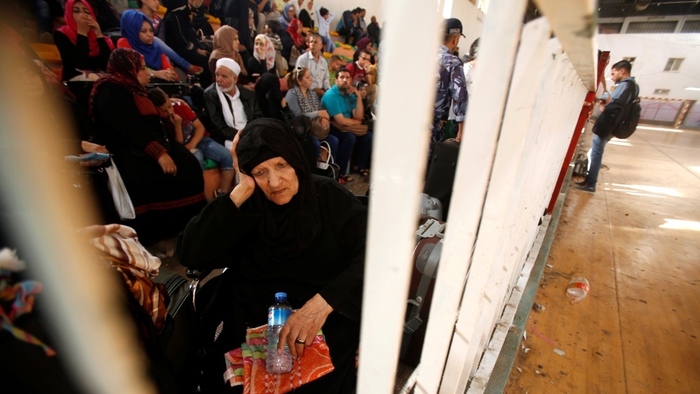 A woman waits for a travel permit to cross into Egypt through the Rafah border crossing after it was opened for four days by Egyptian authorities, in the southern Gaza Strip, June 1, 2016 [Reuters]