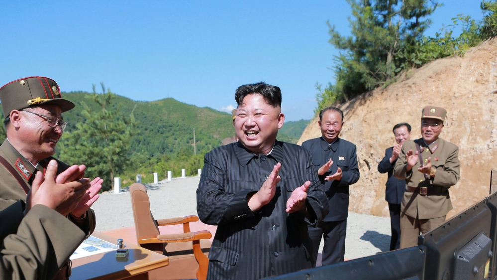 North Korean leader Kim Jong Un reacts with scientists and technicians of the DPRK Academy of Defence Science after the test-launch of Hwasong-14 in this undated photo released by KCNA
