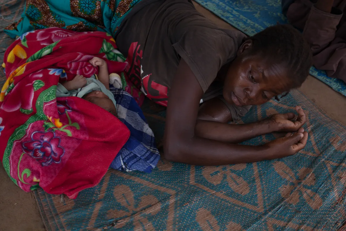 On the 13th of June 2018, a woman and her child nap in Bombe Bakari, Cameroon. The day before, from 6 PM to midnight, their village, Issi, has been taken over by the armed group “Siriri”. The newly ar