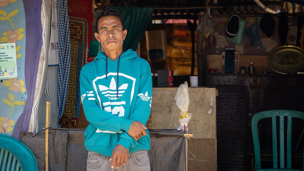 Samsun outside his tent where he started living after the earthquake. The flooding destroyed his livelihood and he cannot return to his village