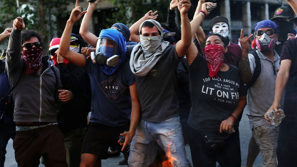 Demonstrators holding rocks during a protest against Chile’s government in Santiago, Chile