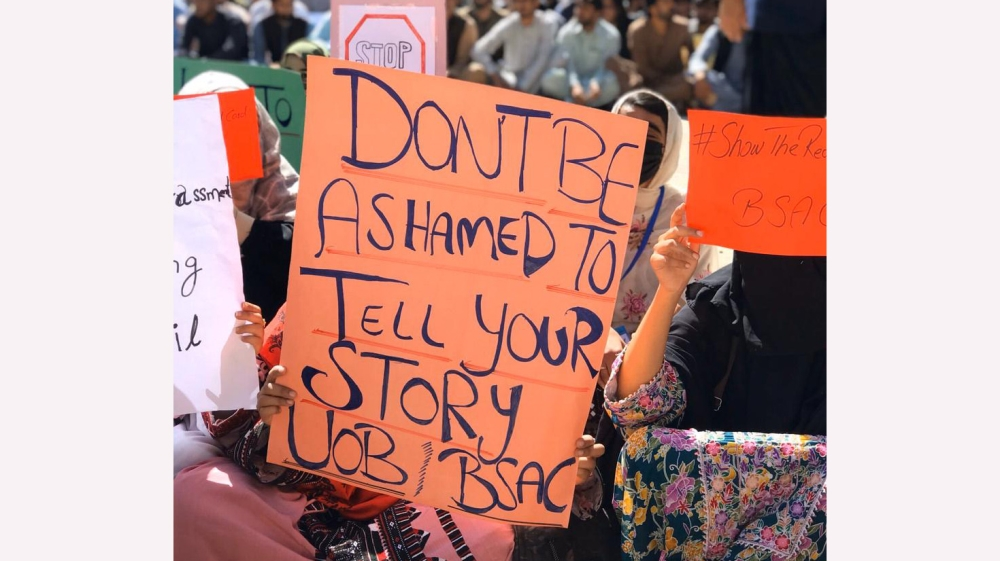 Female protesters hold placards during a demonstration at the University of Balochistan