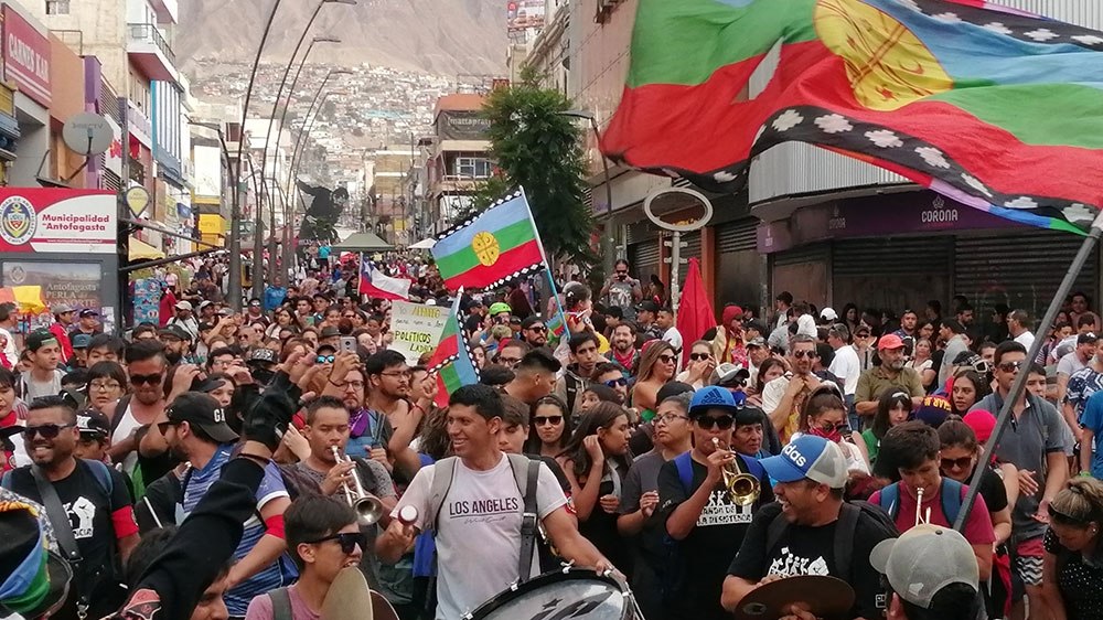 A band energises protesters marching Monday in Antofagasta, in northern Chile