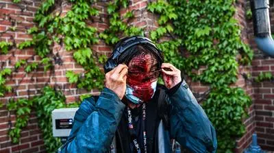 NBC News journalist Ed Ou bleeds after police started firing tear gas and rubber bullets near the 5th police precinct following a demonstration to call for justice for George Floyd