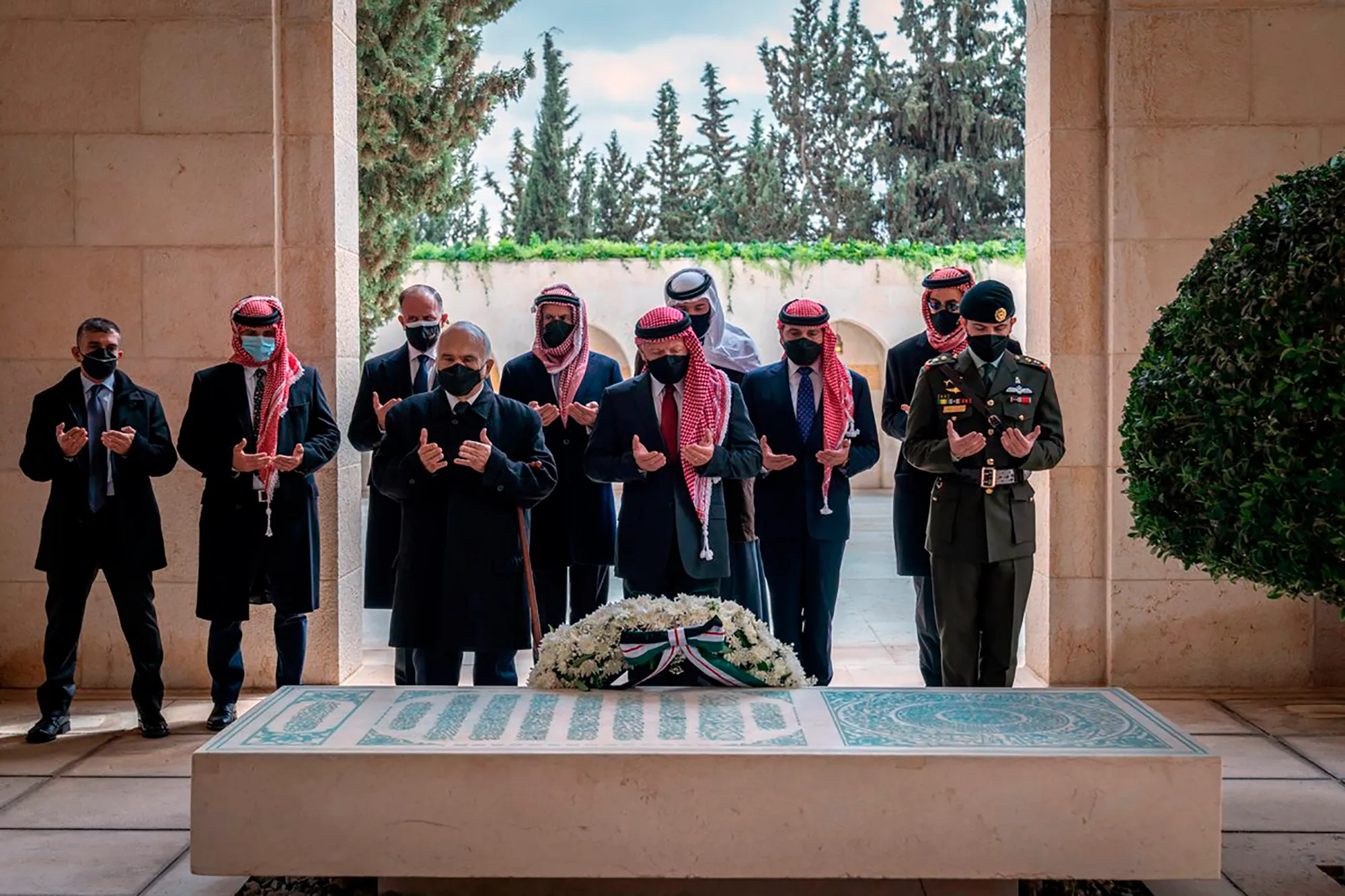 Jordan’s King Abdullah II, centre, Prince Hamzah, second left, and others visit the tomb of the late King Hussein to mark the centenary of the establishment of the Emirate of Transjordan [Royal Court Twitter account via AP]