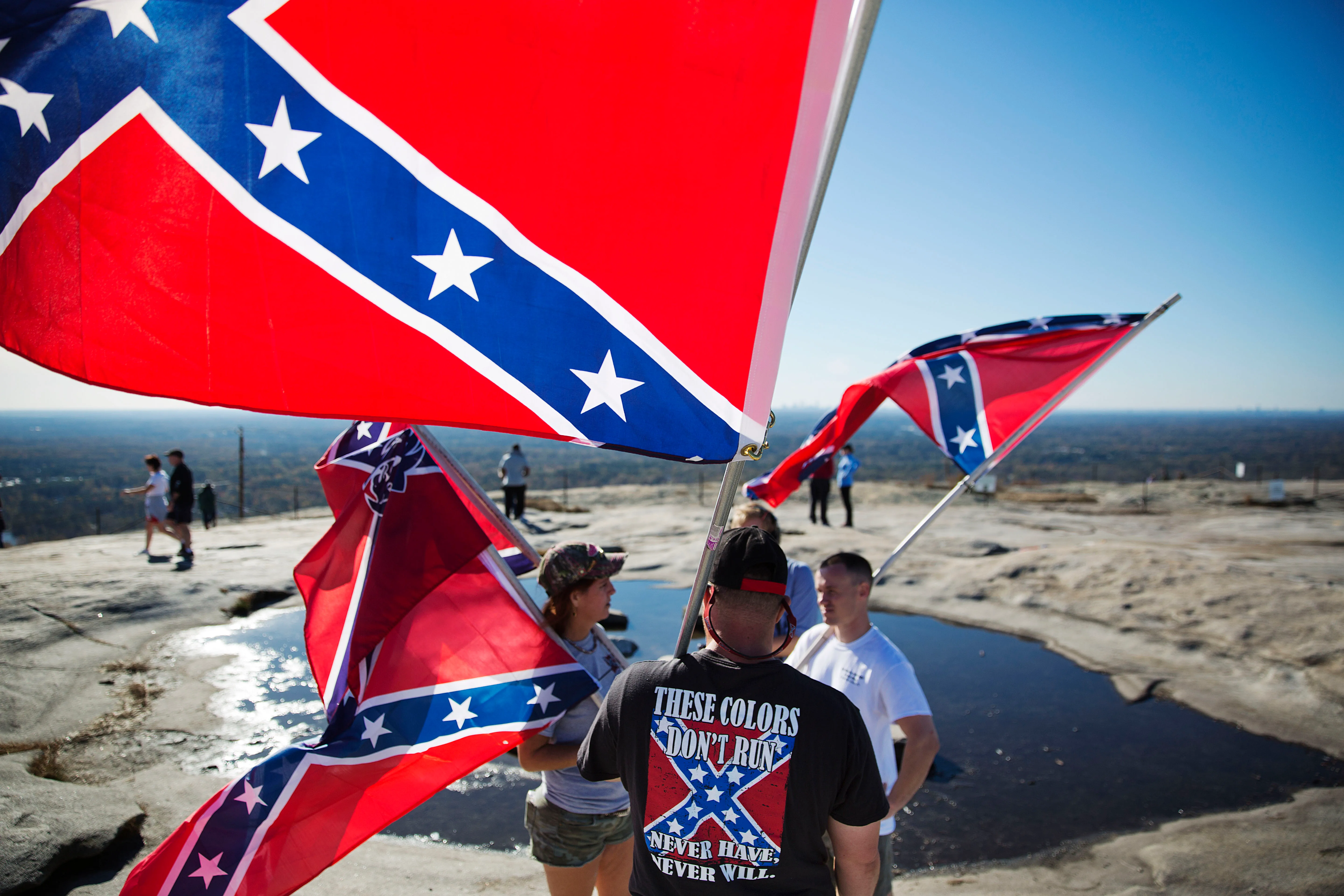 Confederate flag supporters gather at the top of Stone Mountain after hiking up during a 2015 rally [File: David Goldman/AP Photo]