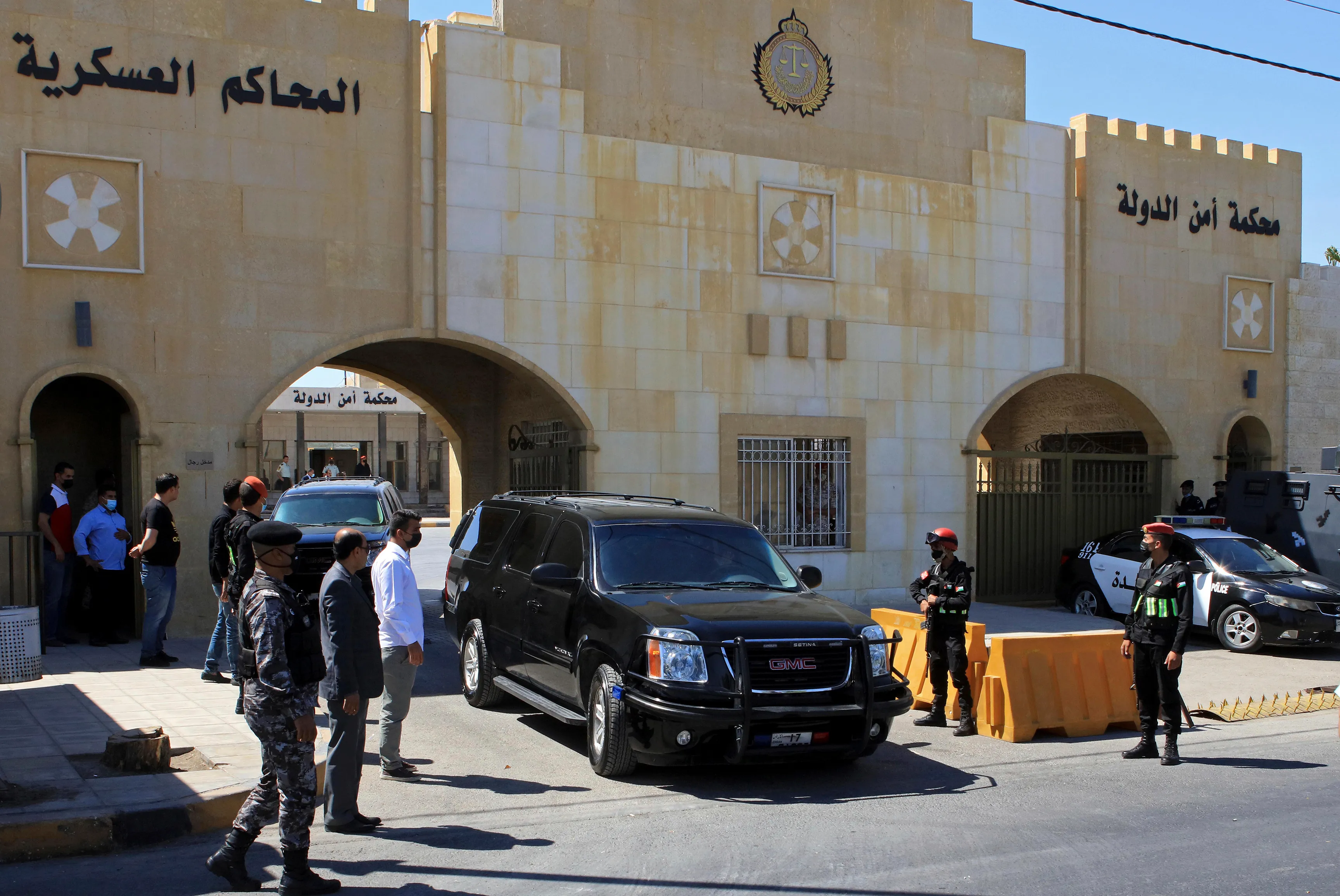 Bassem Awadallah, a former royal adviser, leaves a state security court in a vehicle after the first session of his trial, in Amman, Jordan [Raad Adayleh/AP Photo]