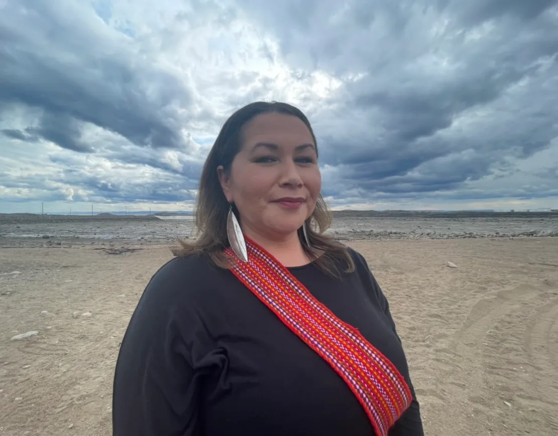 A photo of a person wearing a red sash.