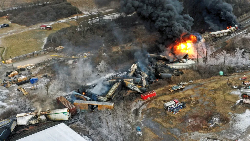 A photo shows the a fire blazing in the aftermath of a train derailment in East Palestine, Ohio in February