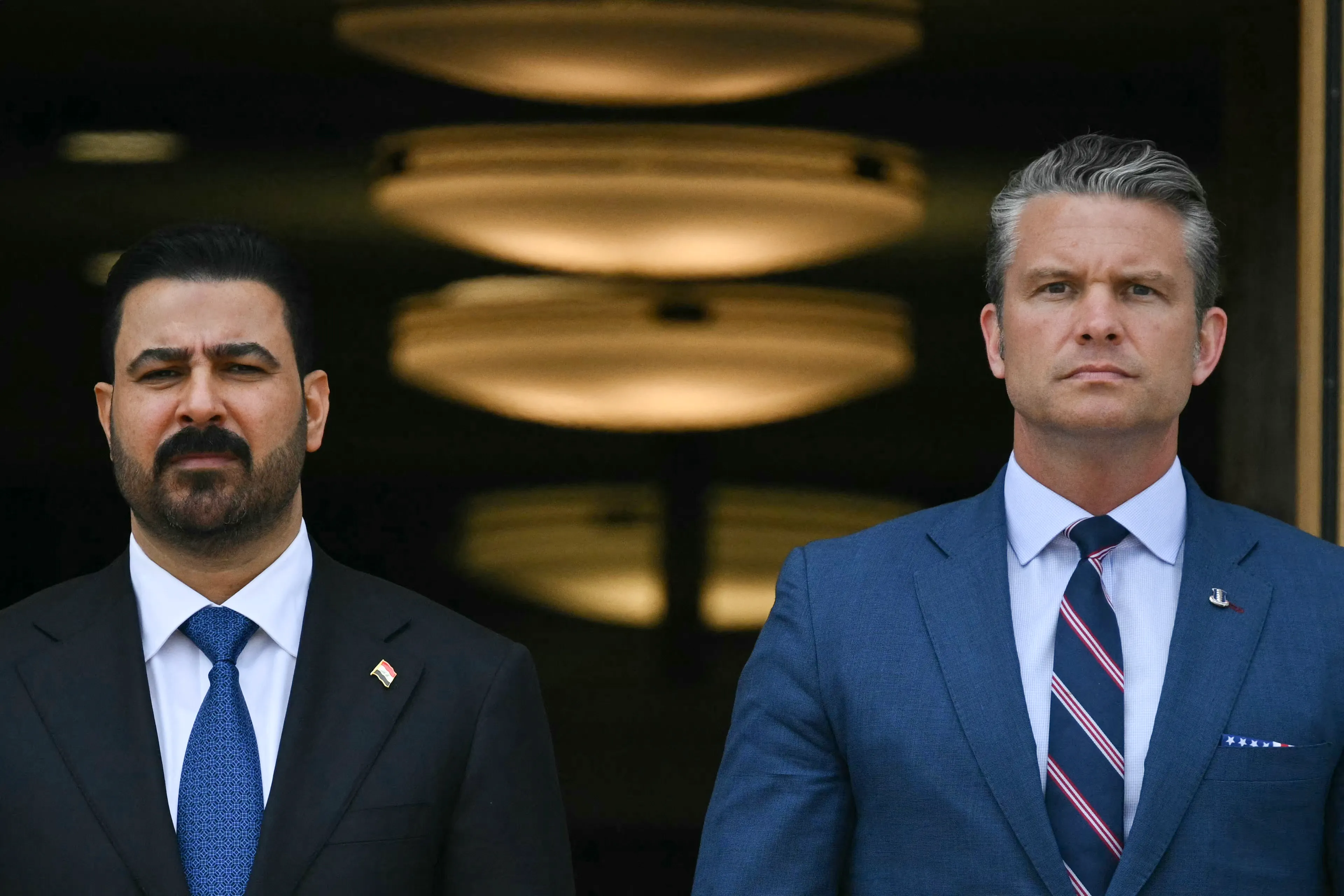 US Defense Secretary Pete Hegseth greets Iraqi Prime Minister Ali al-Zaidi (L) during an arrival ceremony at the Pentagon in Washington, DC, on July 14, 2026. (Photo by Drew ANGERER / AFP)